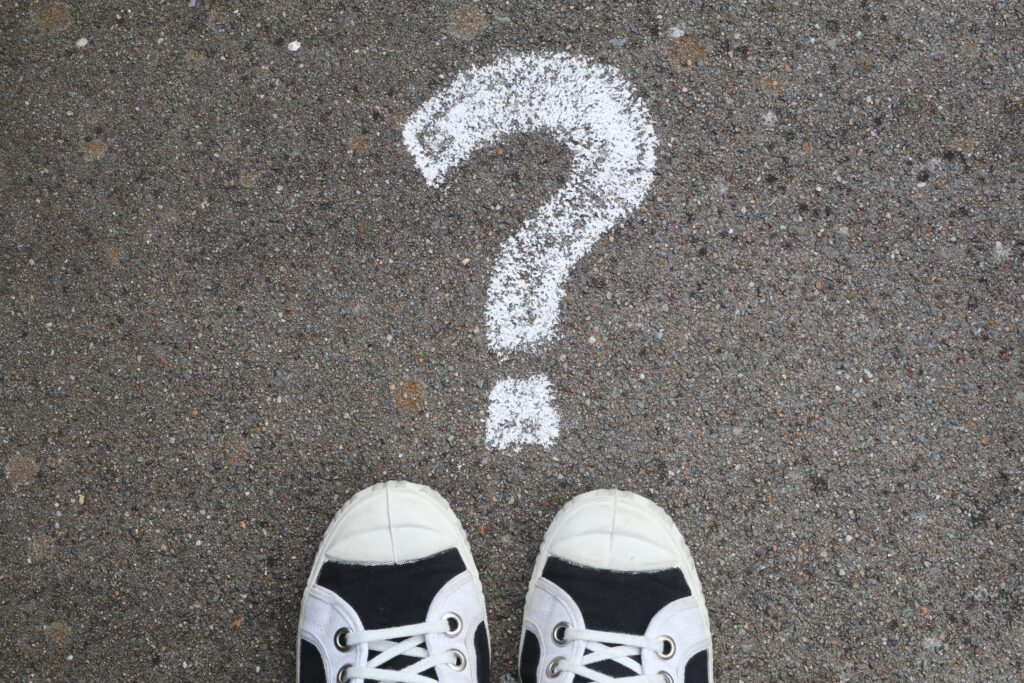 Two shoes with a question mark in front of them
