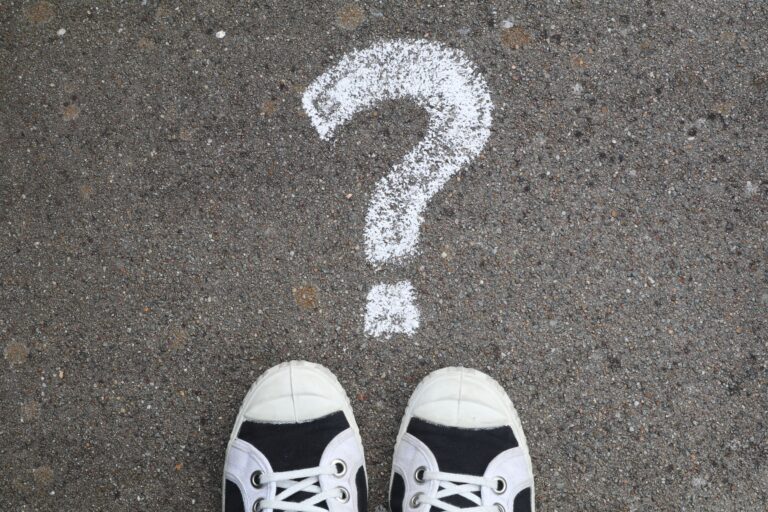 Two shoes with a question mark in front of them