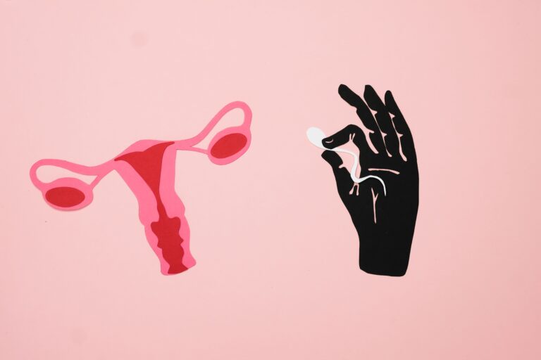 Female reproductive organ and a hand holding a pill
