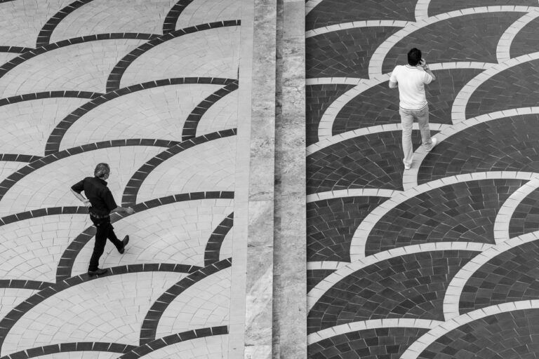 two people on different sides on a grayscale floor
