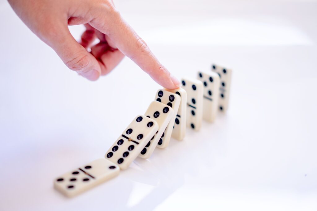 Finger pushing over dominos