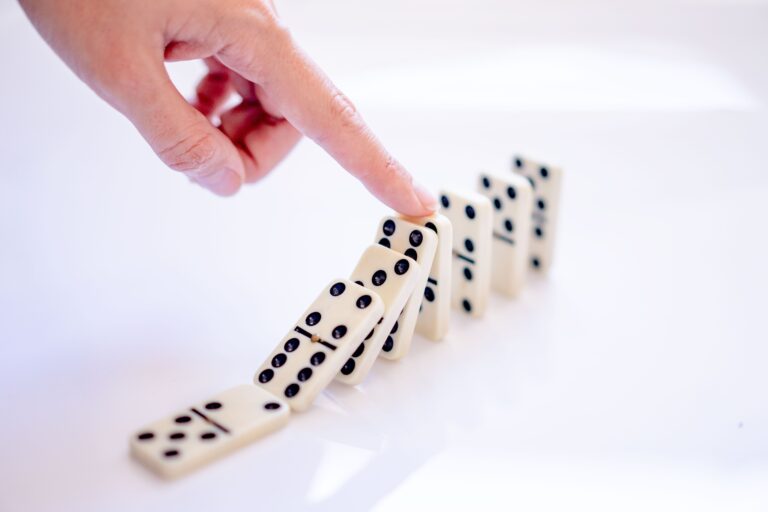 Finger pushing over dominos