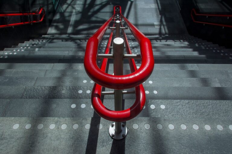 A red handrail on some stairs