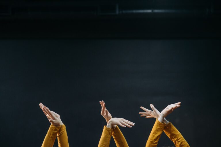 Three pairs of hands crossing themselves